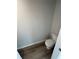 Half bathroom with modern fixtures, toilet, and wood-look flooring at 528 Earnest Ln, Temple, GA 30179