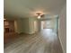 Spacious open-concept living room area with ceiling fan, hardwood floors, and neutral paint at 25 Yellow Brick Way, Covington, GA 30014