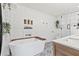 Bright bathroom with a soaking tub, modern vanity, decorative plants, and patterned tile flooring at 3967 Manson Se Ave, Smyrna, GA 30082
