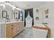 Luxurious bathroom featuring double vanity, soaking tub, and decorative accents with patterned tile floor at 3967 Manson Se Ave, Smyrna, GA 30082