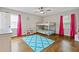 Bright bedroom with bunk beds, wood floors, and light-filled windows dressed with pink curtains at 3967 Manson Se Ave, Smyrna, GA 30082