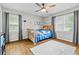 Relaxing bedroom with wood floors, a ceiling fan, and natural light shining through the windows at 3967 Manson Se Ave, Smyrna, GA 30082