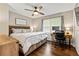 Comfortable bedroom with ceiling fan, wood floors, and desk area by the bright window at 3967 Manson Se Ave, Smyrna, GA 30082