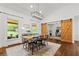 Dining room with hardwood floors, natural light, and stylish sliding barn doors at 3967 Manson Se Ave, Smyrna, GA 30082