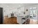 Bright kitchen boasts white cabinets, stainless steel appliances, hardwood floors and a cozy breakfast bar at 3967 Manson Se Ave, Smyrna, GA 30082