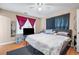 Bedroom with neutral colored walls, hardwood floors and a bed with red curtains at 2171 Wilson Nw Ave, Atlanta, GA 30314