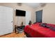 A bedroom featuring hardwood floors, a TV on a stand, and a red comforter at 2171 Wilson Nw Ave, Atlanta, GA 30314