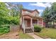 Inviting two-story home featuring a classic front porch and mature landscaping for a serene curb appeal at 2171 Wilson Nw Ave, Atlanta, GA 30314
