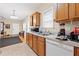 Well-equipped kitchen featuring wood cabinets, a double sink, and views into the living room and entry at 2171 Wilson Nw Ave, Atlanta, GA 30314