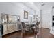An elegant dining room boasts a mirrored buffet, modern chandelier, and a round dining table with stylish chairs at 2865 Lenox Ne Rd # 211, Atlanta, GA 30324