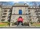 Elegant condo building with a red awning, manicured lawn, and symmetrical facade at 2865 Lenox Ne Rd # 211, Atlanta, GA 30324