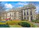 Elegant apartment building with red awning and manicured landscaping, offering a luxurious living environment at 2865 Lenox Ne Rd # 211, Atlanta, GA 30324
