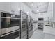 Modern kitchen features stainless steel appliances, white cabinets, and elegant lighting at 2865 Lenox Ne Rd # 211, Atlanta, GA 30324