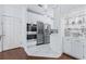 Modern white kitchen with stainless steel appliances, wine fridge, and sleek marble floors at 2865 Lenox Ne Rd # 211, Atlanta, GA 30324