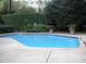 Inviting community pool with a green privacy fence and a serene setting for relaxation and recreation at 2865 Lenox Ne Rd # 211, Atlanta, GA 30324