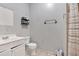 Well-lit bathroom with ceramic tiled floor, a white vanity, and a shower at 902 Allene Sw Ave, Atlanta, GA 30310