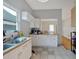 Bright kitchen with a double sink, white cabinets, and view into another room at 902 Allene Sw Ave, Atlanta, GA 30310