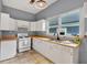 Bright kitchen with white cabinets, neutral backsplash, and tiled floors at 902 Allene Sw Ave, Atlanta, GA 30310