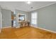 Bright living room with wood floors, neutral walls, and a view into the kitchen at 902 Allene Sw Ave, Atlanta, GA 30310