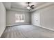 Spacious bedroom with neutral gray color palette, ceiling fan, and a large window with wooded view at Lot 1 Perkins Rd, Dallas, GA 30157