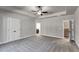 An expansive bedroom features neutral tones, carpet, a ceiling fan, and access to bath and stairs at Lot 1 Perkins Rd, Dallas, GA 30157