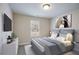 Well-lit bedroom features neutral walls, carpeted floor, and a comfortable bed with stylish gray bedding at Lot 1 Perkins Rd, Dallas, GA 30157