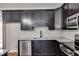 Stylish kitchen with dark cabinets, granite countertops, and stainless steel appliances at Lot 1 Perkins Rd, Dallas, GA 30157