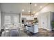 Bright kitchen and dining area featuring white cabinetry, stainless steel appliances, and wood-look flooring at Lot 1 Perkins Rd, Dallas, GA 30157