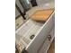 Close-up of a farmhouse-style kitchen sink with granite countertops and a cutting board at Lot 1 Perkins Rd, Dallas, GA 30157
