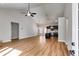 Open-concept living room with hardwood floors, tall ceilings, modern lighting, and adjacent dark-toned kitchen at Lot 1 Perkins Rd, Dallas, GA 30157