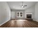 Bright living room featuring hardwood floors, a stone fireplace, and a large window overlooking the backyard at Lot 1 Perkins Rd, Dallas, GA 30157