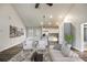 Open-concept living room with a dining area and kitchen featuring white cabinetry and stainless steel appliances at Lot 1 Perkins Rd, Dallas, GA 30157