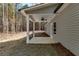 Covered patio with fan, white posts, and view of a wooded backyard at Lot 1 Perkins Rd, Dallas, GA 30157