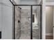 Glass enclosed shower featuring large tiles and a built-in bench at Lot 1 Perkins Rd, Dallas, GA 30157