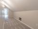 View of the attic featuring neutral walls, carpet, and an open doorway at 1555 New Ne St, Atlanta, GA 30307
