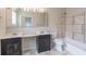 Clean bathroom featuring double sinks, a bathtub with shower, and tiled floors at 1555 New Ne St, Atlanta, GA 30307