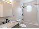 Bathroom featuring a marble countertop sink, tiled shower and bathtub, and modern black hardware at 1555 New Ne St, Atlanta, GA 30307