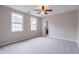 Spacious bedroom featuring a ceiling fan, neutral walls, and plush carpet at 1555 New Ne St, Atlanta, GA 30307