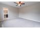 Comfortable bedroom offering a ceiling fan, neutral colors, and access to the bathroom at 1555 New Ne St, Atlanta, GA 30307