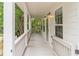 Long, white, covered front porch with gray flooring and white railings, with exterior lights at 1555 New Ne St, Atlanta, GA 30307