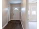Front hallway featuring dark wood floors, a front door with glass, and neutral walls at 1555 New Ne St, Atlanta, GA 30307