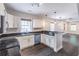 Well-appointed kitchen flowing into open living space, with bright white cabinets and granite counters at 1555 New Ne St, Atlanta, GA 30307