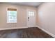 Living room features hardwood floors, a window with blinds, and a white door with glass panes at 1555 New Ne St, Atlanta, GA 30307