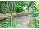 Backyard with a stone patio, mature trees, and lush landscaping at 1798 Melrose Sw Dr, Atlanta, GA 30310