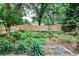 Backyard featuring a well-maintained lawn, mature trees, and newly installed wood fence at 1798 Melrose Sw Dr, Atlanta, GA 30310