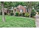 Charming brick home featuring a well-manicured lawn, lovely front yard landscaping, and welcoming entrance at 1798 Melrose Sw Dr, Atlanta, GA 30310