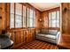 Cozy sunroom with wood paneling, terracotta floors, and abundant natural light at 1798 Melrose Sw Dr, Atlanta, GA 30310