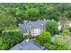 Aerial view of apartment complex surrounded by mature trees and featuring a community pool at 3636 Habersham Nw Rd # 2101, Atlanta, GA 30305