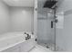 Bathroom with a separate glass-enclosed shower featuring rainfall shower head and a soaking tub at 3636 Habersham Nw Rd # 2101, Atlanta, GA 30305