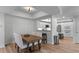 Dining room with a table and view to the kitchen with white cabinets and stainless steel appliances at 3636 Habersham Nw Rd # 2101, Atlanta, GA 30305